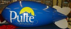 helium advertising blimp - blue color blimp with Pulte logo